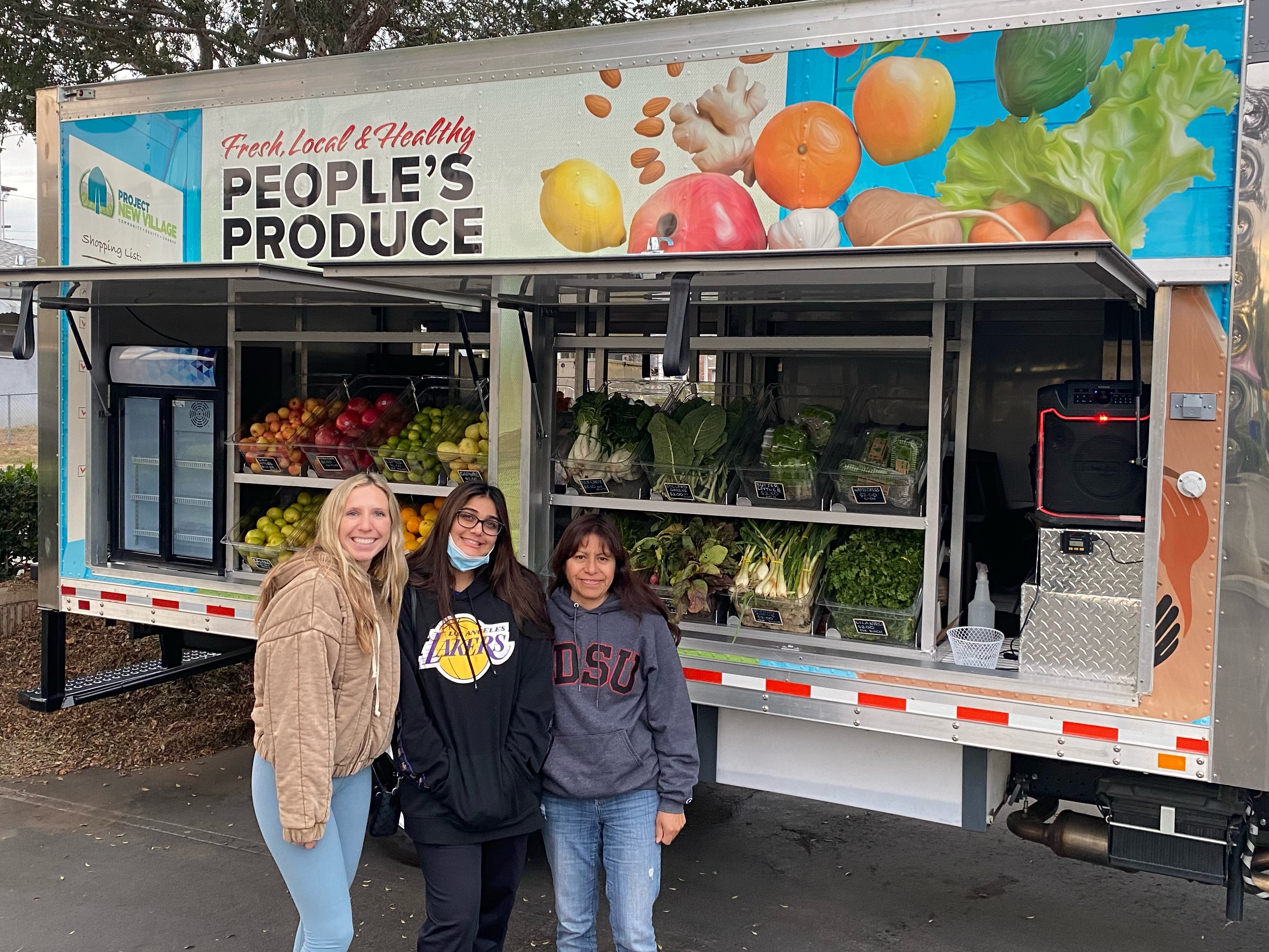 Three DPD students in front of a Local Produce truck