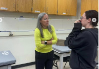 Professor Kim Detwiller talking with student