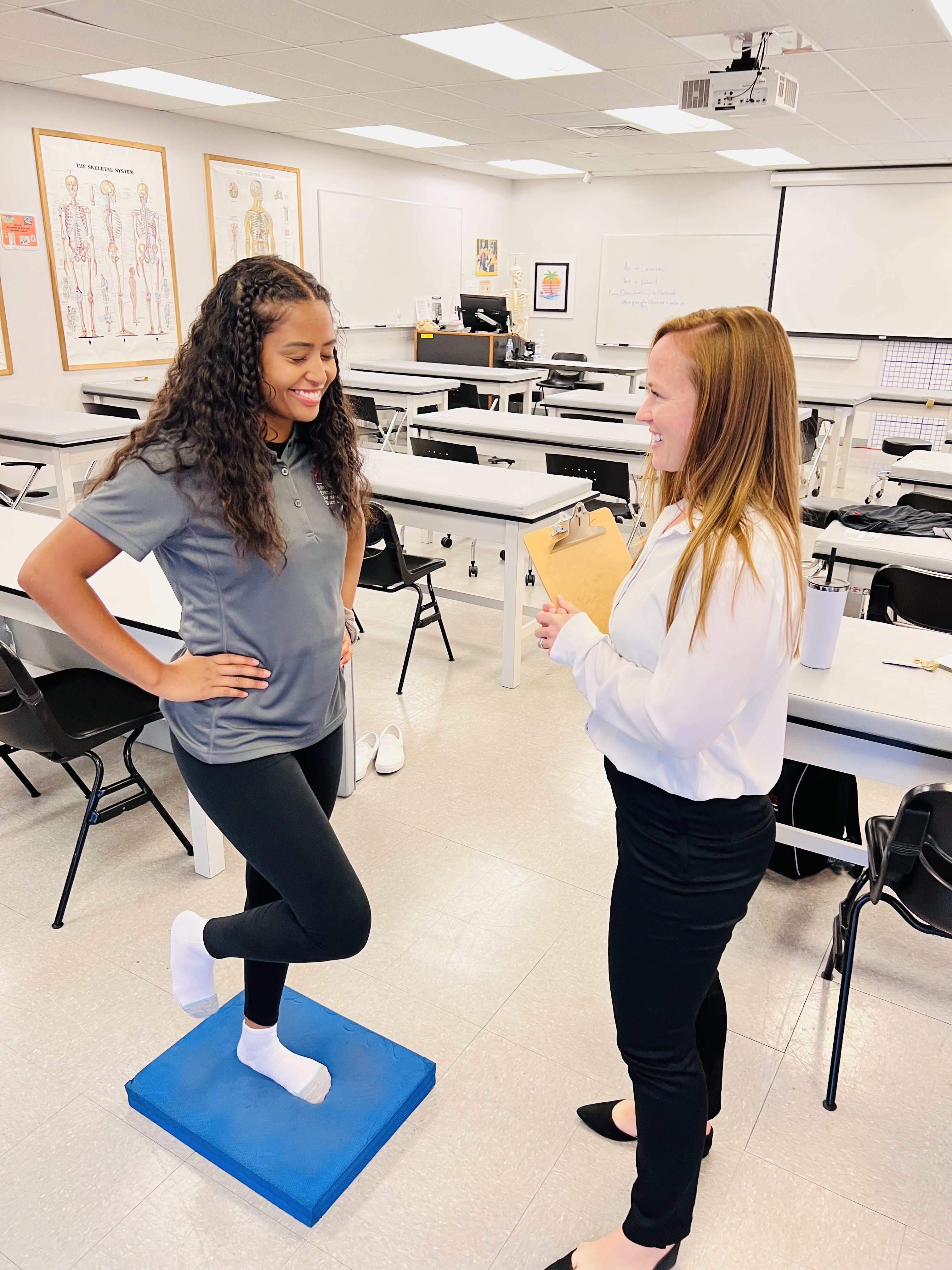 Professor Rawlins with student balancing on one foot