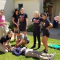 Students practicing putting on a neck brace on another student