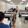 Student standing straight next to a measuring string